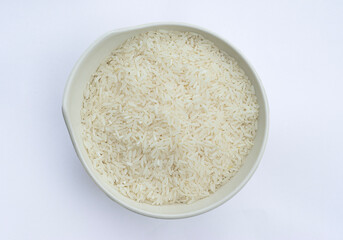 Asian short grain rice in white bowl . Uncooked rice or raw rice. Thai - Vietnam rice in white bowl isolated on white background.