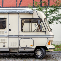 Old vintage motorhome parked on city street
