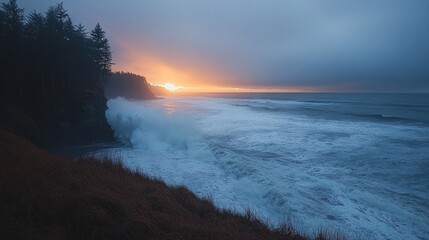 Obraz premium Dramatic sunset over the ocean with crashing waves and a cliff in the foreground.