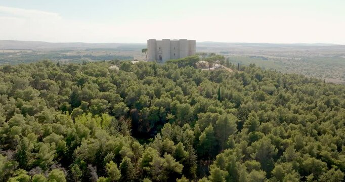 Aerial view of Castel del Monte. It is a castle situated on a hill near Andria, in Puglia, Italy. It's a fortress built in the Middle Ages by Frederick II of Swabia. There is a dense forest around it.