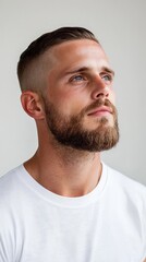 Fototapeta premium A man with a beard and a shaved head