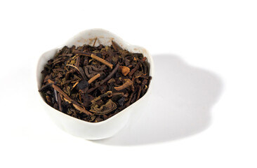 Dried tea leaves isolated on white background. Tea is a caffeinated beverage, an infusion made by steeping the dried leaves, leaf buds, or leaf stalks of the Camellia sinensis plant in hot water.