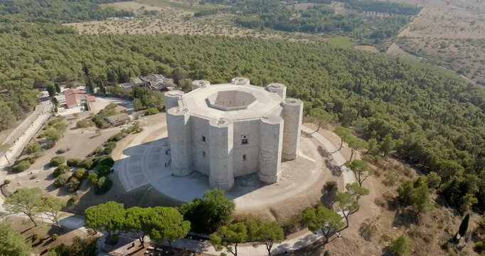 Aerial view of Castel del Monte. It is a castle situated on a hill near Andria in the Apulia region, Italy. A medieval fortress famous for its bold octagonal plan. There is a dense forest around it.