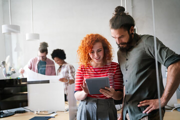 Group of business people and software developers working as a team in modern startup office