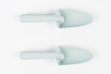 Garden tools with blue grips on a white background