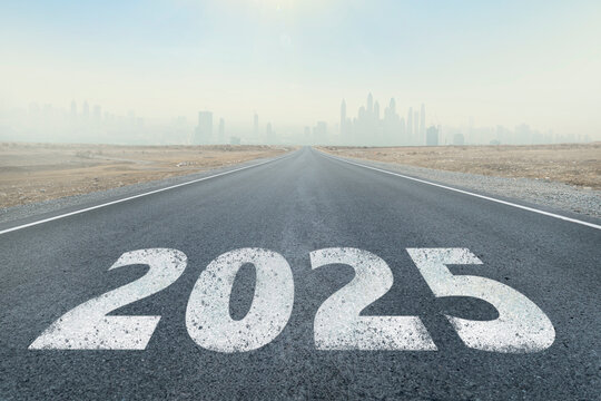 the road from 2004 to 2005. inscription 2025 written on highway road in middle of empty asphalt road and beautiful blue sky. Concept for vision new year 2025. future vision