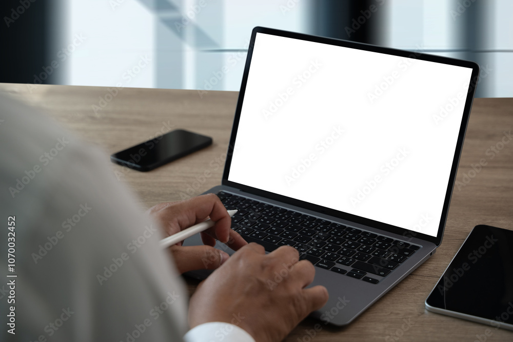Poster man working on laptop computer with blank screen laptop computer mock up in office