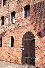 a red brick building with a wooden door  