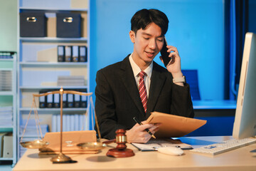 Serious pensive lawyer working at desk in office.