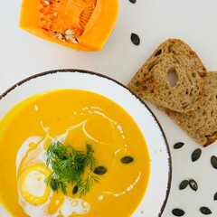 Pumpkin Soup with Coconut Cream in Bowl with Toast