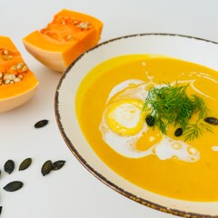 Pumpkin Soup with Coconut Cream in Bowl with Toast