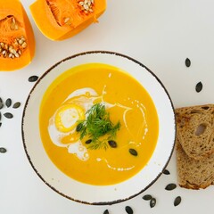 Pumpkin Soup with Coconut Cream in Bowl with Toast