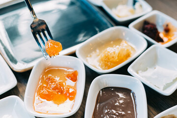 Plate of assorted fruit jam, showcasing vibrant colors and textures, perfect as a sweet addition to a traditional Turkish breakfast spread or served alongside fresh bread.