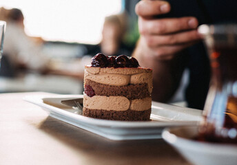 Single-serving chocolate and fruit mousse cake topped with fresh berries, showcasing a decadent blend of rich cocoa flavor and vibrant fruits for an elegant dessert experience