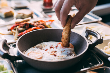 Traditional Turkish-style fried eggs (sahanda yumurta) served in a copper pan, capturing the rustic simplicity and delicious golden yolks of this classic breakfast dish