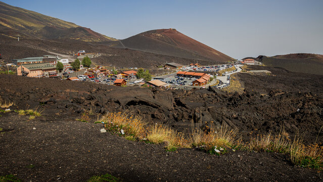 Etna volcanic landscape with black lava, Catania, Sicily, Italy, Etna (also called Mongibello) vegetation, black solidified volcanic lava. Postcard from a trip to Sicily.