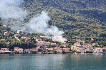 Green mountain backdrop for lakeside village scene.