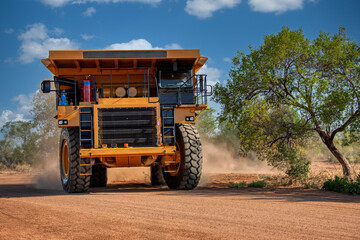 Obraz premium mining truck in a diamond mine, driving on dirt road gravel, brand new delivery