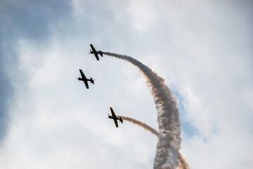 A pilot flies an aerobatic propeller plane in the sky