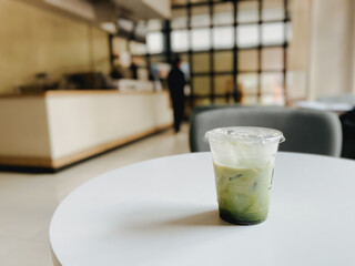 A cup of matcha green tea latte in a cafe restaurant or coffee shop
