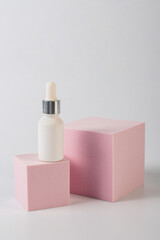 Plastic white tube for cream or lotion. Skin care or sunscreen cosmetic with stylish props on white background.
