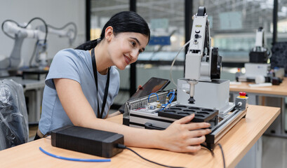 Hispanic engineer woman working on AI technology in robotics electronics engineering laboratory. University students' research project is programming robot machine with intelligent mechanical control