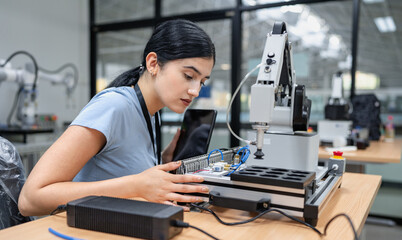 Hispanic engineer woman working on AI technology in robotics electronics engineering laboratory....