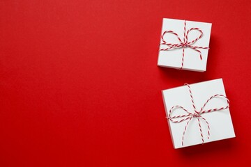 Beautiful gift boxes tied with bows on color background 