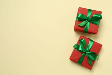 Beautiful gift boxes tied with bows on color background 
