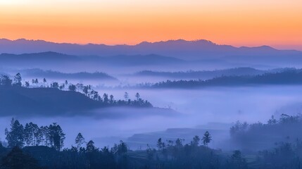 Fototapeta premium A picturesque sunrise paints the sky with vibrant hues as a thick blanket of fog rolls across a valley, shrouding the distant mountains in mystery.