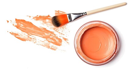 A small jar of peach-colored paint with a paintbrush on a white background.