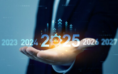 Businessman touching growth chart from success year 2025.Business plan in company 2025.Development to business success and achievement in 2025 year.New plans,aim,goals and visions in business.