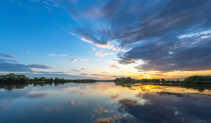 Beautiful sunset over a lake with a reflection of the sky on the water