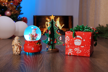 Childs handmade toys from plasticine. Christmas and New Year Gift Under the Tree with Garland and Ornaments. Festive Fireplace with Christmas Decor Creating a Cozy Holiday Atmosphere.