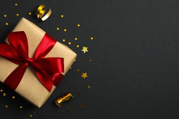Beautiful gift box tied with bow on color background 