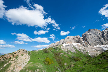 Green plains, snowy mountains. Blue sky and snowy mountains. Snowy mountains of Tunceli. Pülümür Valley, Buyer Mountain, Sarıgül Plateau, Buyer Waterfall.Munzur, Tunceli, Türkiye.
