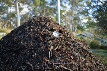turning a compost pile in a community garden. compost full of microorganisms. sustainable...