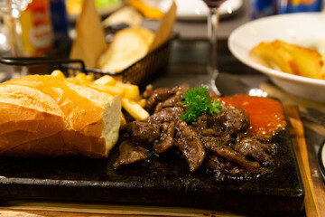 Elegant Restaurant with Steak, Bread, and Wine – Perfect Setting for a Party and Fine Dining Experience
