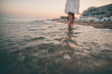 Barefoot Steps Through Shallow Waves at Sunset