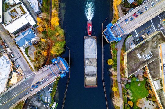 Drone Shot of Tugboat and Barge Passing Under Fremont Bridge on Lake Union, Seattle