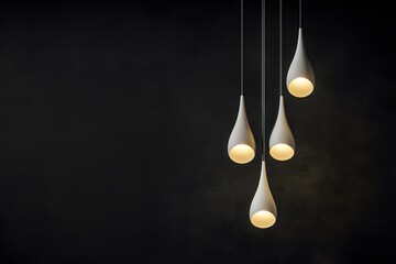 White teardrop-shaped pendant lights hanging against a black backdrop