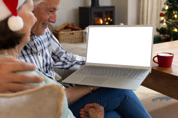 Christmas time, Senior couple enjoying holiday video call at home with laptop and coffee, copy space