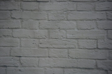 Construction, unusual imitations and drawings on fabric, fabric material. Beautiful masonry of gray, white bricks on a fabric background.