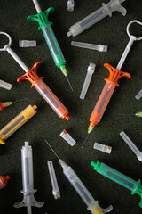Multicolored syringes on a black background