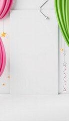 Blank white paper with pink and green wavy fabric and stars on a white background.