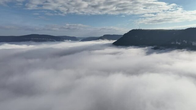 Clouds covering a valley aerial Millau sunny day 