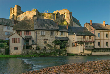 The riverside buildings based under the ancient chateau with autumn fallen leaves