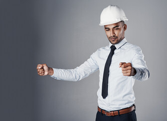 Pretending, holding and man with invisible document, blueprint of engineer with protection gear in studio. Helmet, manager and civil engineering with contractor and thinking with grey background