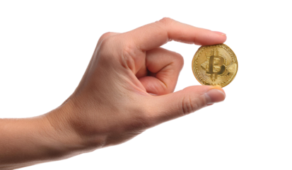 Bitcoin gold coin on the hand.