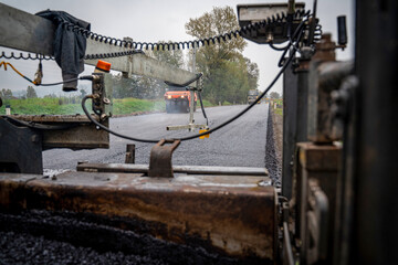 Close-Up of Asphalt Paver in Action from Low Angle Perspective